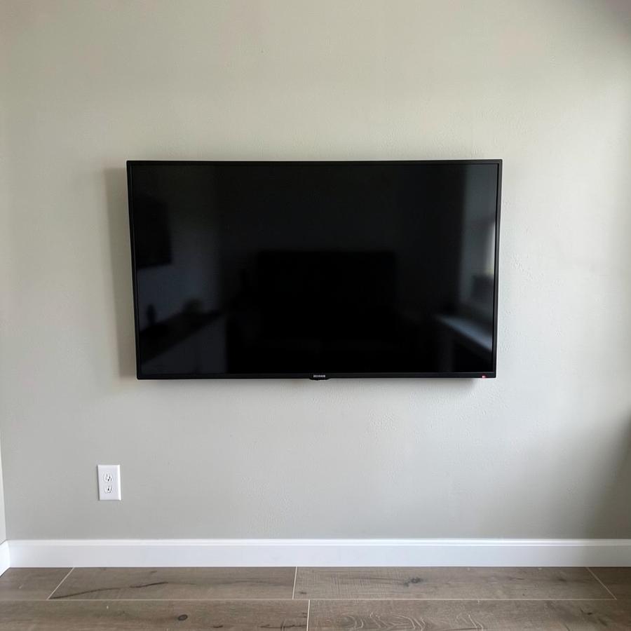 Television mounted level on a wall with no visible cables